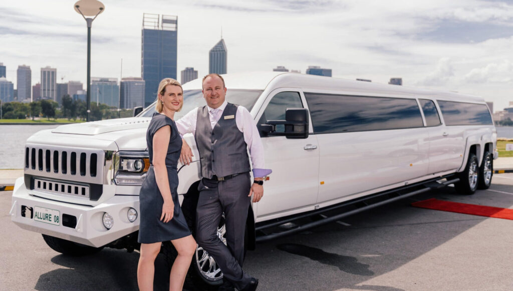 A limousine with a professional chauffeur in front of a city skyline